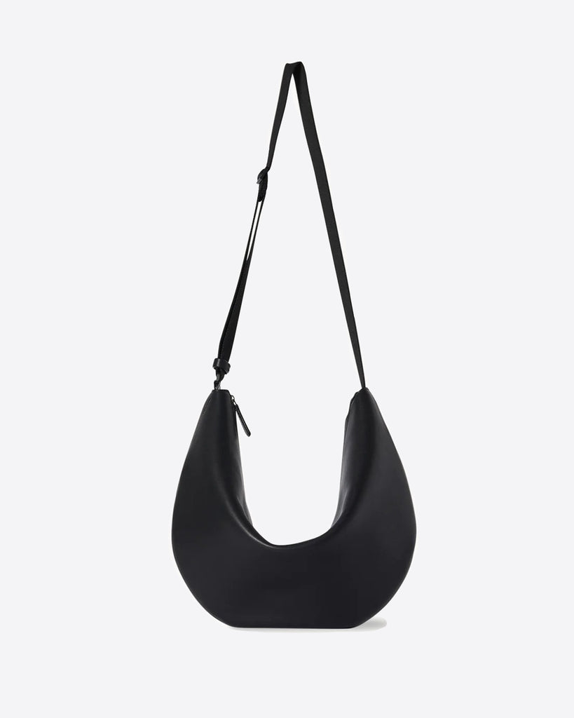 The Row Crossbody Crescent in black 